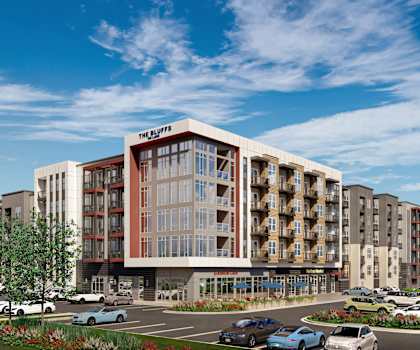 The Skyline is a modern apartment complex with a parking lot in front.