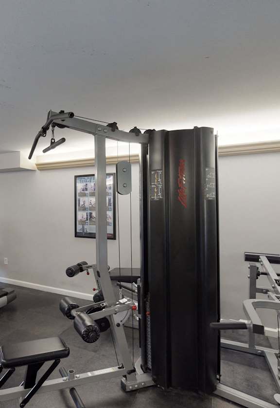 a gym with treadmills and other exercise equipment in a building
