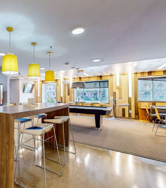 a clubhouse with a bar and a pool table at Bierman Place, Minneapolis, Minnesota