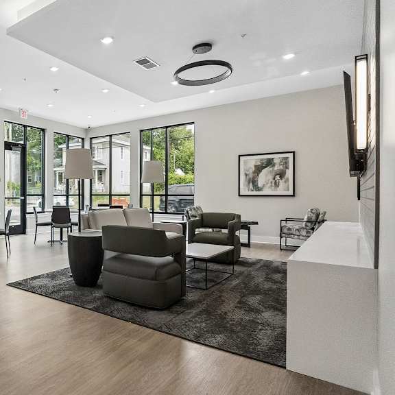A modern living room with a dining table and chairs.