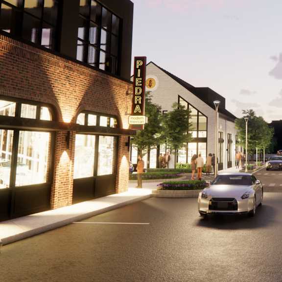 A street view with cars and buildings on both sides at The Union Flats at Fishers District, Fishers, 46037