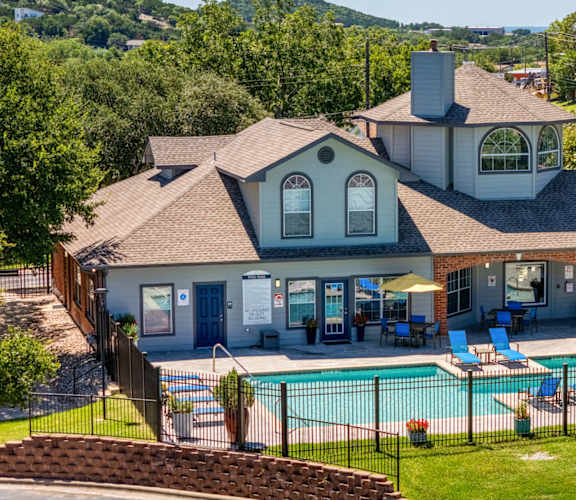 A house with a pool in the backyard. at Clear Creek Meadows Apartments, Texas