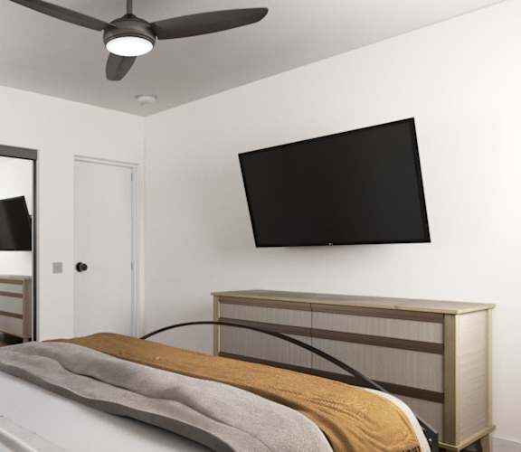 a bedroom with a large bed and a tv on the wall at Ocean Edge @ Laguna Beach Apartments, Laguna Beach