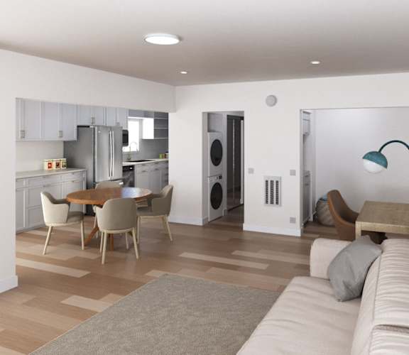 A modern living room with a dining area and kitchen in the background at Ocean Edge @ Laguna Beach Apartments, California