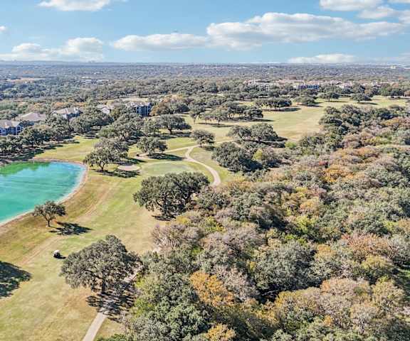 A beautiful aerial view of a park with a lake and trees at TalaVera Apartments, San Antonio, Texas