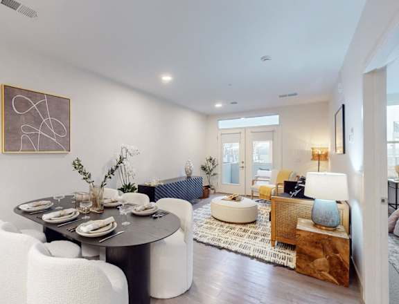 a dining room with a table and chairs and a living room