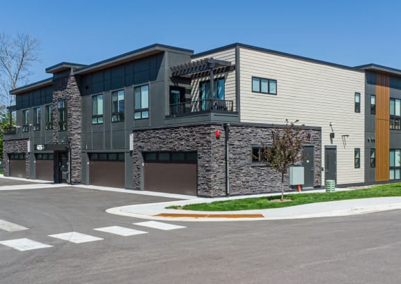 a rendering of a three story building with a parking lot in front of it at The Stax of Long Lake, Long Lake, MN