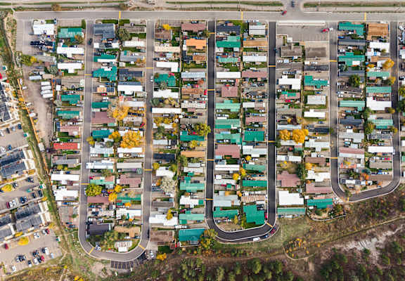 A bird's eye view of a residential area with houses and roads.