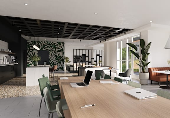 A modern office space with a long wooden table and chairs.