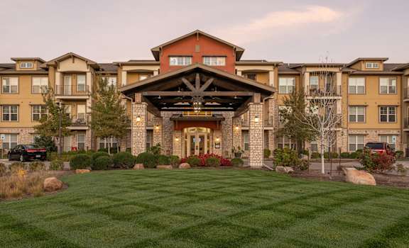 a large building with a lawn in front of it