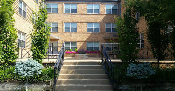a staircase in front of a brick apartment building