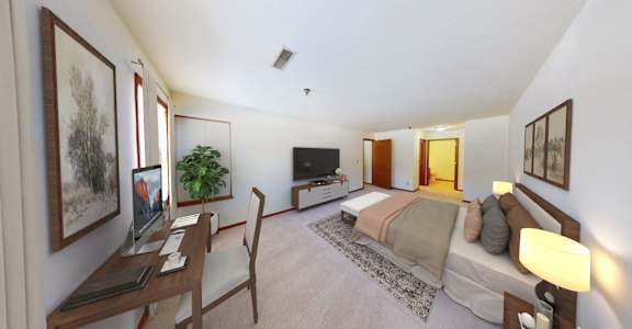 A bedroom with a bed, desk, and chair.