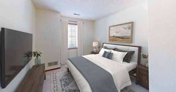 A bedroom with a large bed and a flat screen TV.