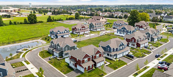 A suburban neighborhood with houses and a pond.