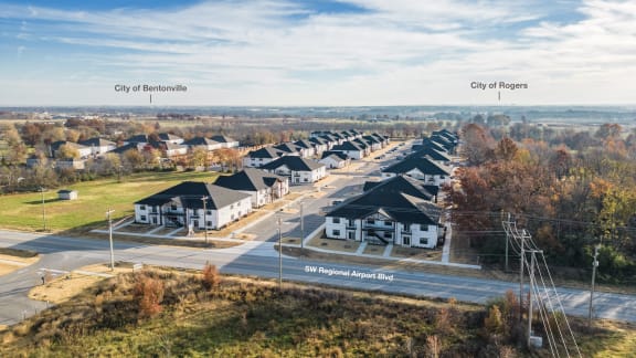 an aerial view of a neighborhood of houses on a street