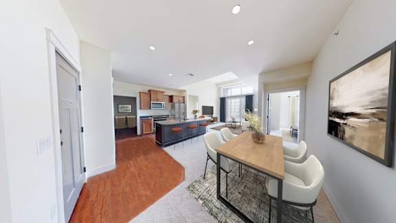 A modern living room with a wooden table and white chairs.