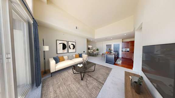 A living room with a white couch and a coffee table.