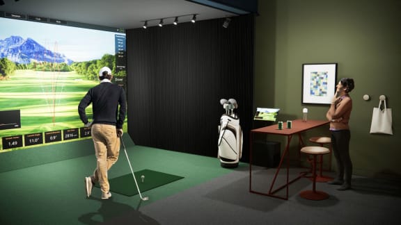 a man and a woman playing golf in front of a screen