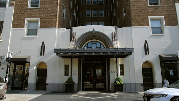 A building with a large arched entrance and a sign that reads "4701" is shown.