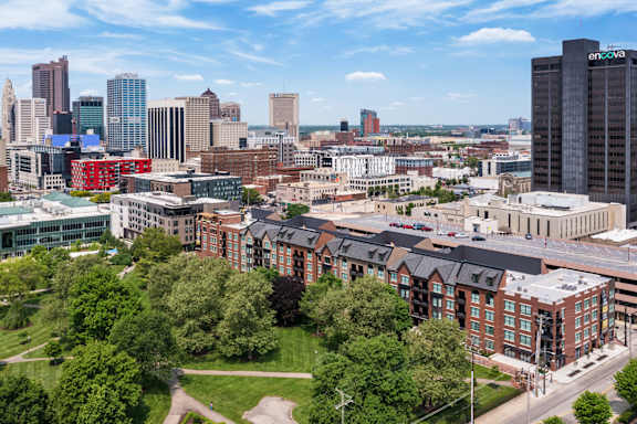 an aerial view of the city with buildings and trees