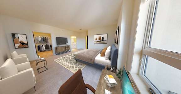 a bedroom with a bed and a couch in a hotel room
