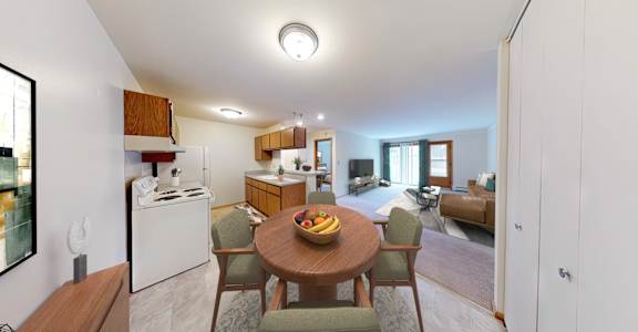 A modern kitchen with a dining table and chairs.
