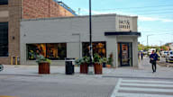 Salt and Sunday is a restaurant with a black sign on a white building.