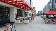 A red awning is on the side of a building.
