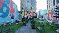 A colorful mural on a wall in a park.