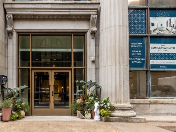 the front of a building with a bronze door and potted plants at The Commonwealth Building, Pittsburgh, 15222