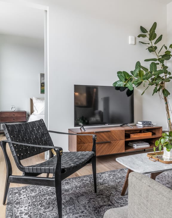 a living room with a couch and a chair and a television at The Commonwealth Building, Pennsylvania