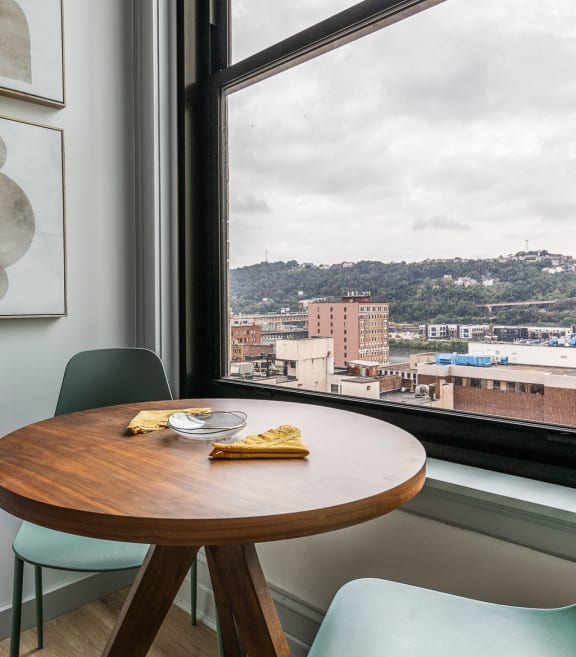 a small table in front of a window with a city view at The Commonwealth Building, Pittsburgh, 15222