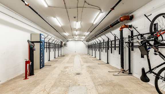 A long hallway with bicycles on the side and a red object on the left. at The Commonwealth Building, Pittsburgh, 15222