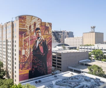 a large mural of a man in a suit on the side of a building