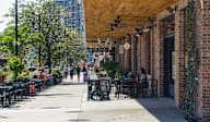 A sunny day at an outdoor restaurant with people dining.