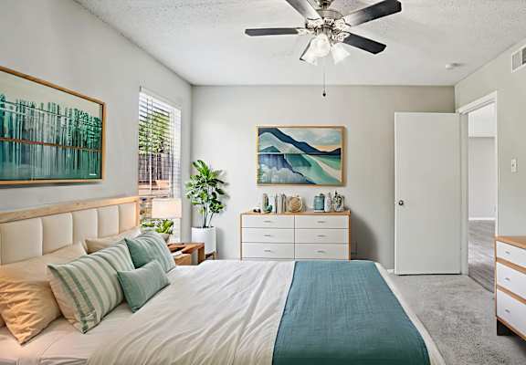 A bedroom with a bed, dresser, and ceiling fan at Keller Oaks, Carrollton, TX 75006