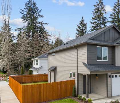 A house with a grey roof and a brown fence.