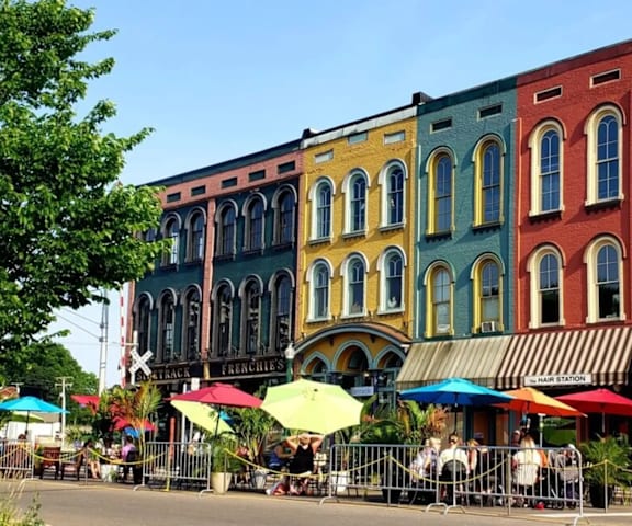 A row of colorful buildings with a street in front.