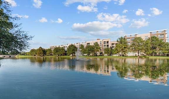 A serene lake with a building in the background.