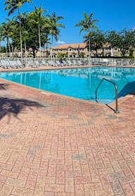 a large swimming pool in front of a house