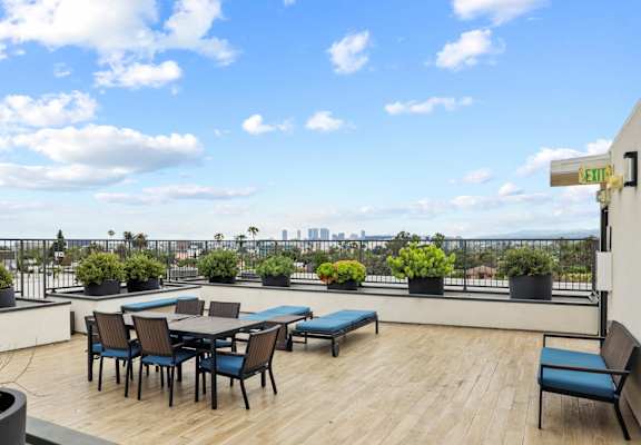 the terrace of a building with tables and chairs on a roof