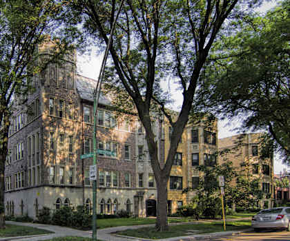 A large building with a green lawn in front of it.