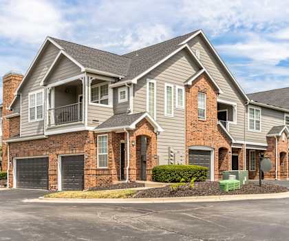 a large house with a driveway and a street in front of it