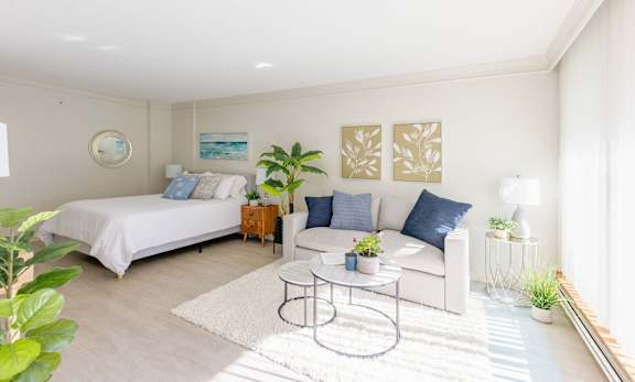 a bedroom with a bed and a couch and a coffee table