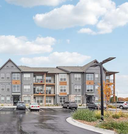 A large apartment complex with a parking lot in front at Notch66, Longmont, Colorado