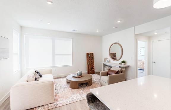 A living room with a white couch and a coffee table.