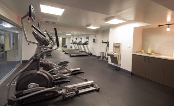 A gym with treadmills, elliptical machines, and other exercise equipment at The Argonne Apartments, Washington, DC, 20009