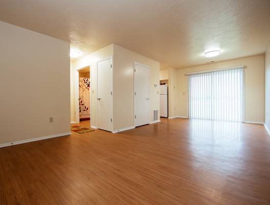 A room with wooden floors and white walls.
