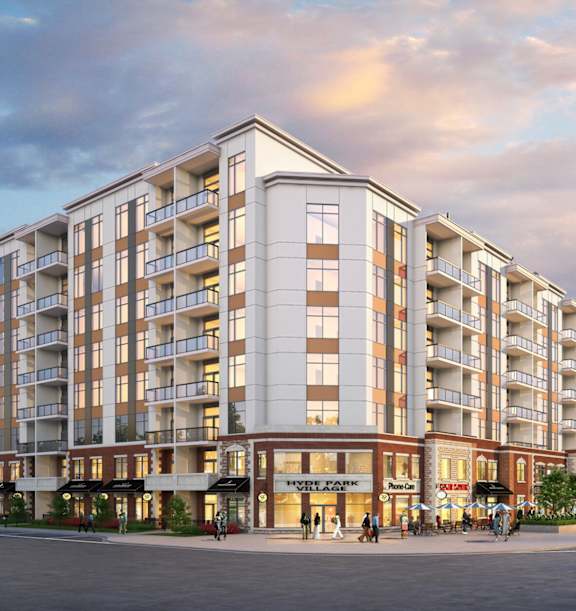 A large apartment building with a parking lot in front.