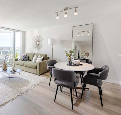 a living room with a round dining table and a couch